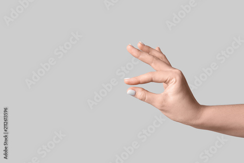 Female hand holding somethi...