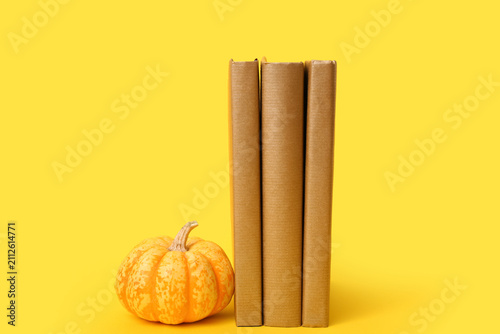 Books and ripe pumpkin on y...