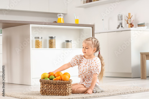 Cute little girl with baske...