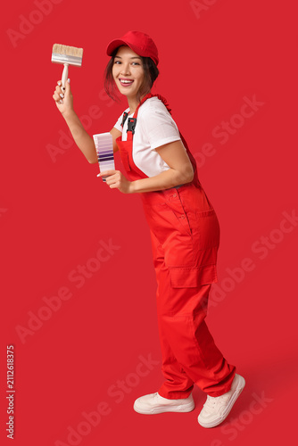Happy female painter with p...