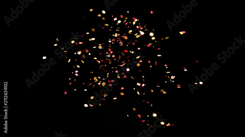 A vibrant explosion of colorful confetti against a black background, creating a festive and celebratory mood.