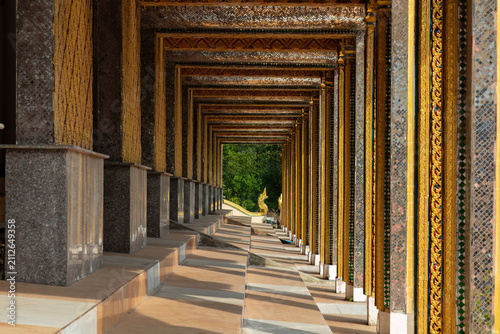 Outdoor corridor at the Buddhist temple of Wat Panthai Norasing in Bangkok, Thailand. 
