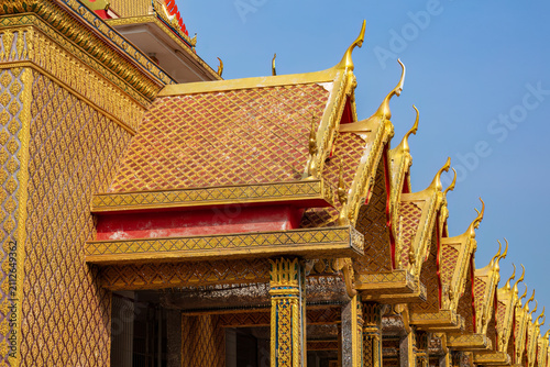 Traditional Thai architecture of the golden temple roof of the Buddhist temple of Wat Panthai Norasing in Bangkok, Thailand. 