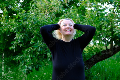 Overcome with delight and amusement, she tilts her head back and laughs freely. Relaxed gestures and a joyful expression create a carefree atmosphere filled with positive energy.