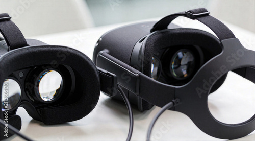 Two virtual reality headsets resting on white table