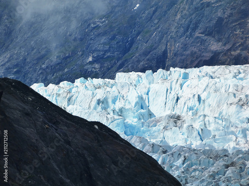 telephoto view of a section of the terminus of the beautiful white and blue Margerie Glacier in southeastern Alaska viewed from a cruise ship in July 2026