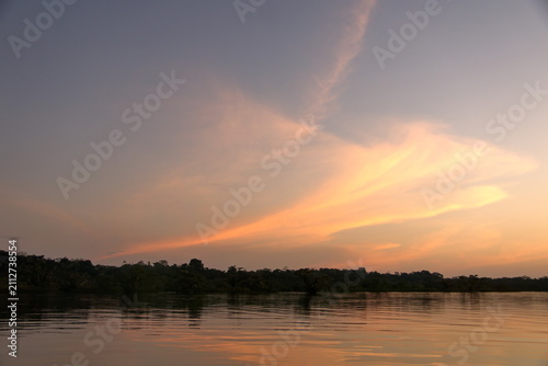 Shore of Laguna Grande in silhouette at sunset, in the Cuyabeno Wildlife Reserve, outside of Lago Agrio, Ecuador