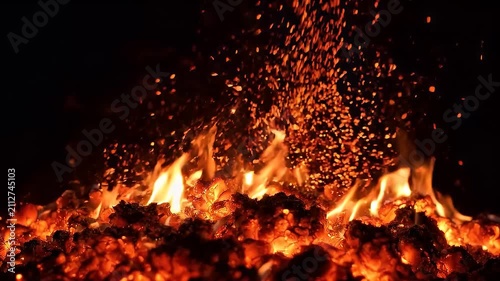 Vibrant Burning Embers and Glowing Fire Sparks Rising Into Dark Night Air Texture
