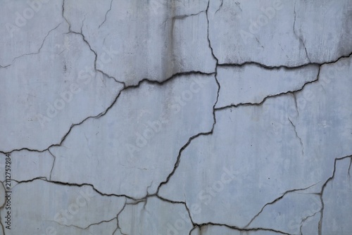 Obraz na płótnie Cracked concrete wall texture showing weathered surface and deterioration patter