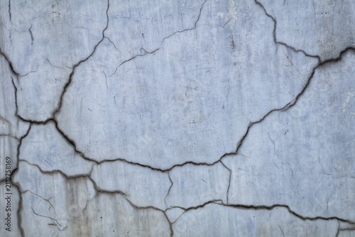 Obraz na płótnie Cracked concrete wall texture showing weathered surface and deterioration patter
