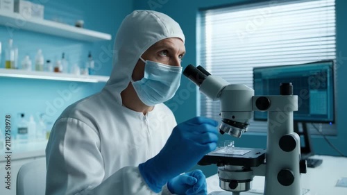 Scientist In Lab Coat And Gloves Examining Microscope Slides In Modern Research Laboratory Setting video clip
