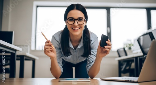Successful young female entrepreneur working with digital tools in modern office