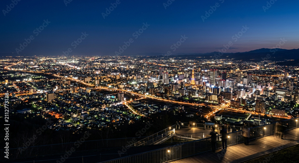 Fototapeta premium Stunning panoramic night view of Sapporo cityscape and observatory deck from Mount Moiwa in Hokkaido Japan