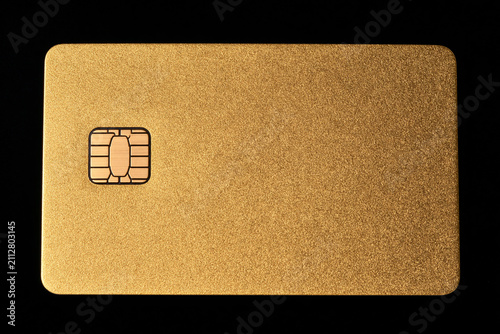 Golden credit card with smart chip on black background