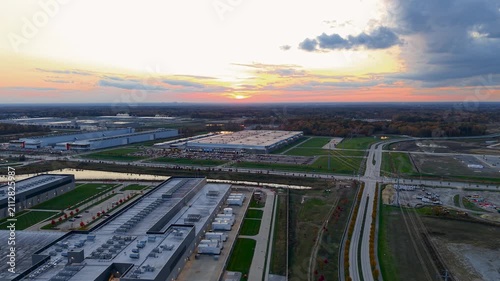 Aerial view of massive data centers and industrial park warehouses at sunset