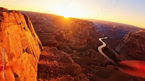 Vast desert canyon landscape with winding river at golden sunset