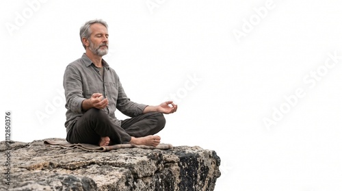 Mature man meditating in lotus position on rocky cliff edge with eyes closed and serene expression Silhouette