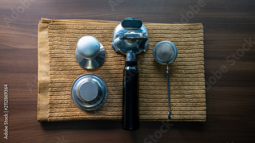 Bild auf Leinwand Top View of Espresso Portafilter Tamper and Coffee Tools on Wooden Background