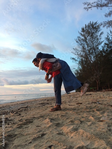 young boy playing on the beach