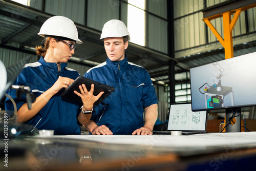 Teamwork in modern industry with detailed technical planning and collaboration.