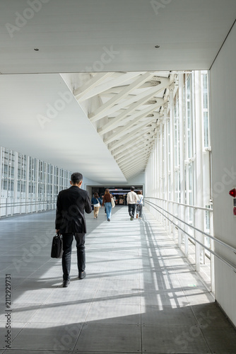 Business People Walking inside Pedestrian Skywalk at Shibuya Hikarie