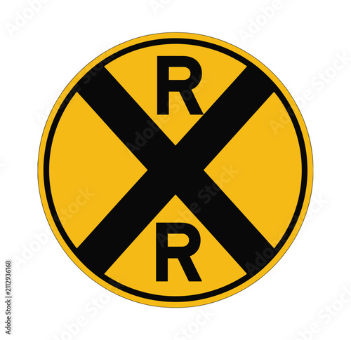 Railroad Crossing Sign: A yellow, circular sign featuring a black X symbol and two R letters, indicating a railroad crossing ahead, designed for traffic safety and awareness.