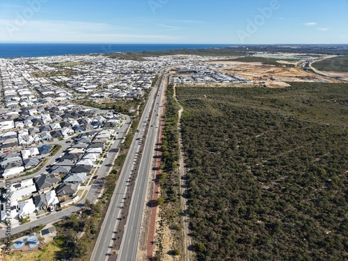Cuadro en lienzo Drone aerial view of coastal suburban development beside native bushland in Pert