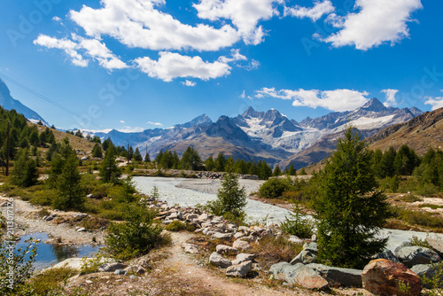 Mountain stream flowing through an alpine meadow in the Swiss Alps