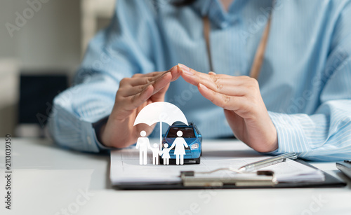 Businesswoman protecting a family and vehicle with insurance coverage concept, symbolizing financial security, risk management, family protection, car insurance policy, and future financial planning.
