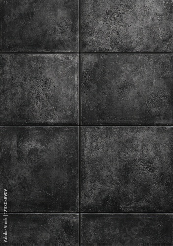 Close-up of dark, weathered, textured stone tiles arranged in a grid pattern