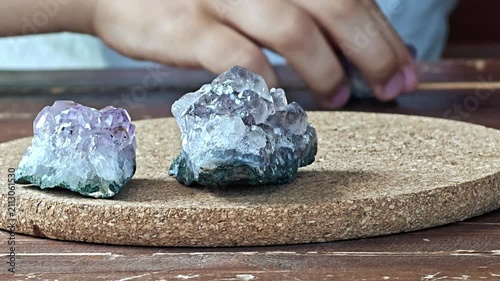 Natural mineral amethyst in hand. Semi-precious multi-colored stones, minerals close-up. Mineralogy. Mineral collection.