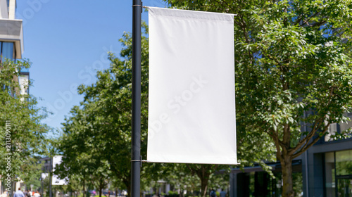 Blank white vertical banner mockup on lamppost with trees