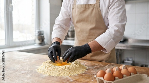 Chef preparing fresh dough with eggs and flour