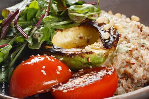 Konstfotografi Healthy grain bowl with grilled avocado and roasted tomatoes, vegetarian