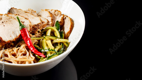 Gourmet sliced roasted meat with zucchini noodles and spicy red chili, zucchini