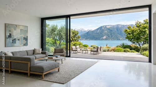 Modern living room with panoramic lake and mountain view, open sliding doors