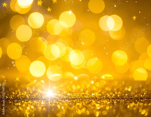 Warm, golden glitter and light abstract. Bright background with bokeh and small stars