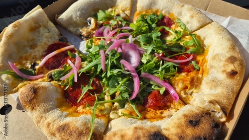Freshly made pizza with toppings served in a takeout box