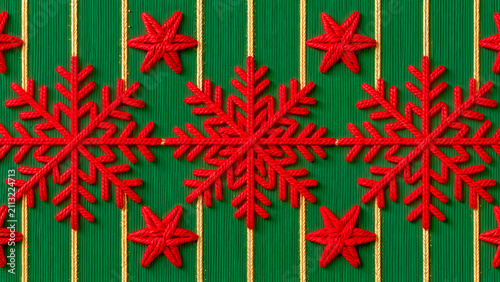 A compact seamless festive background , detailed red rope snowflakes and small stars aligned between vertical golden threads on a textured green surface.
