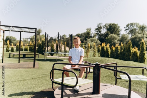 Happy Boy Playing on Modern Playground