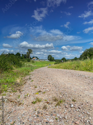 A dirt road winding between the lakes of the Iława Lake District.