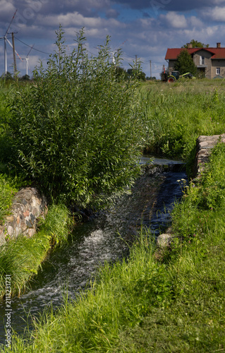 A small stream flowing gently down a small hill. Jelenie Incline, Poland.