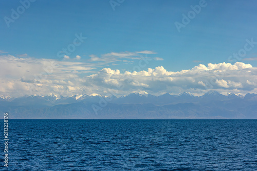 Photography Serene mountain lake Issyk-Kul with distant mountains in Kyrgyzstan