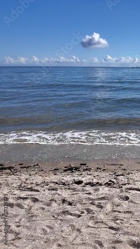 Gentle sea waves washing onto a sandy beach