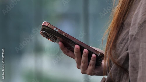 Woman holding smartphone, connecting and communicating using mobile technology