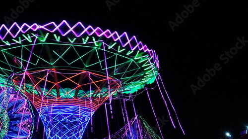 Canvastavla Colorful Neon Wave Swinger Ride Spinning At Night