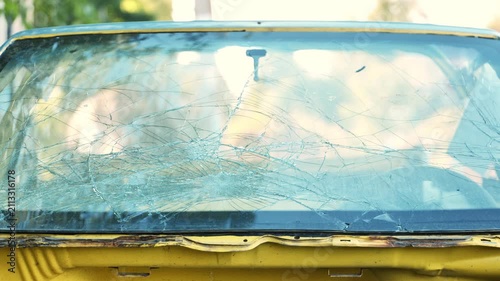 Shattered car windshield showing spiderweb pattern of damage from an accident