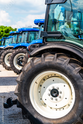 Agricultural machinery dealership displaying tractors outdoors. Agricultural equipment lot.