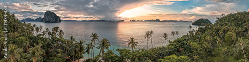 Tropical beach with palm trees on Palawan, the Philippines at sunset
