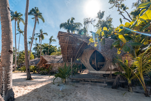 Tropical sand beach in the Philippines with bamboo hut sleeping accomodation